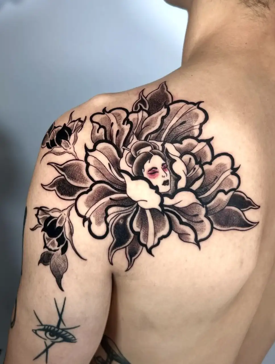 Peony flower with female face tattoo on shoulder by Ayah at Omnia Tattoo Melbourne